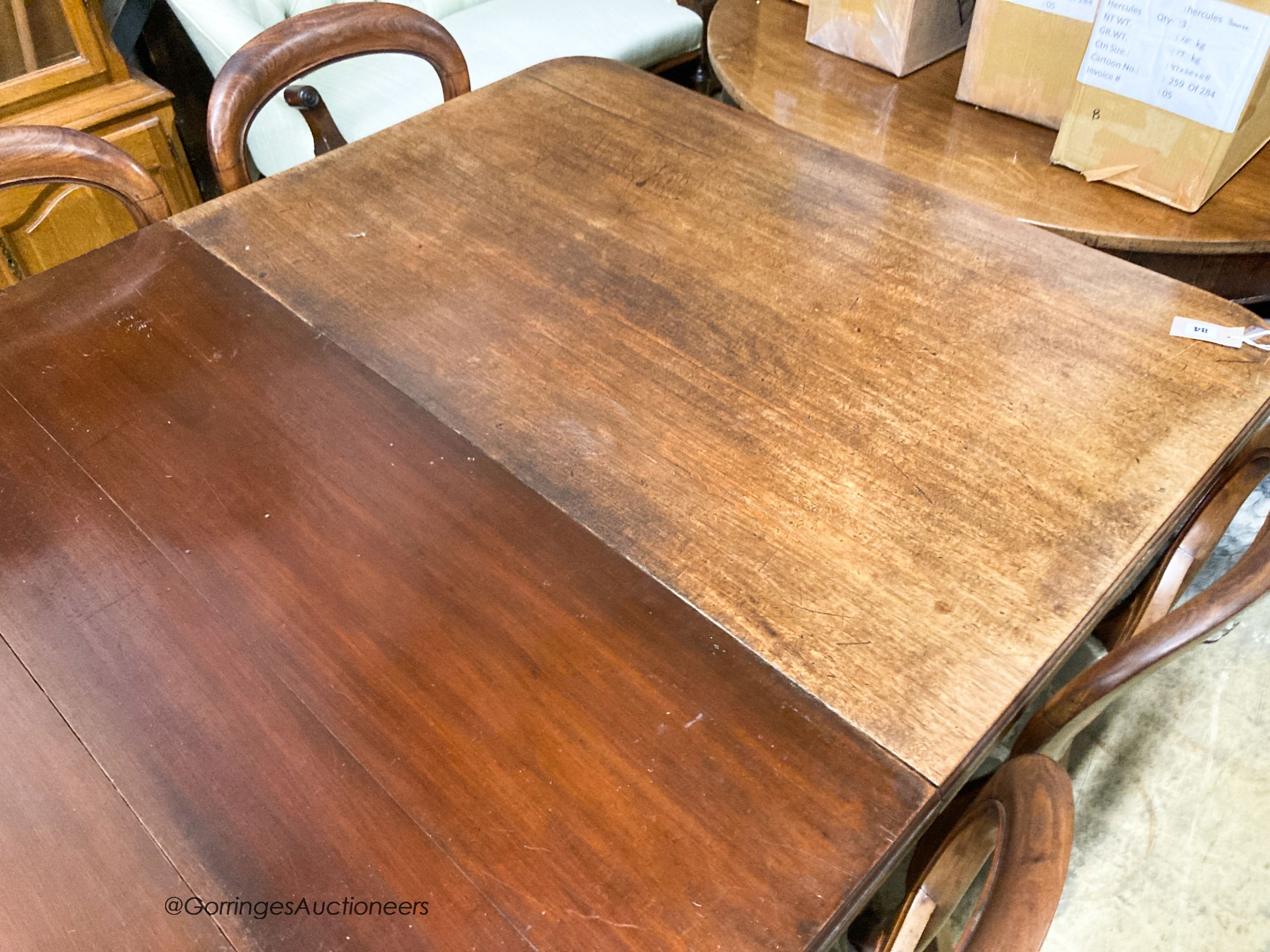 A late Victorian mahogany extending dining table, 238cm extended, two spare leaves, depth 118cm, height 72cm together with a set of eight Victorian mahogany balloon back dining chairs